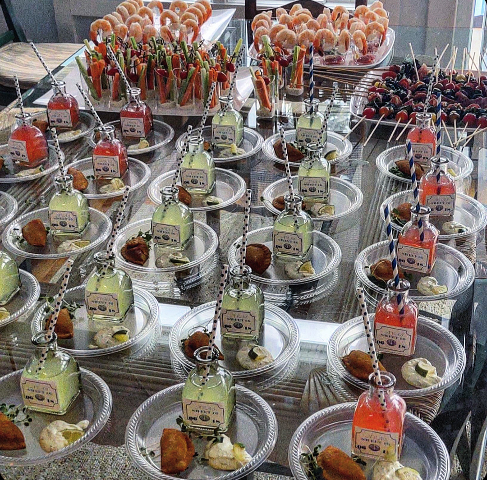 A catered spread of hors d’oeuvres plated on silver trays